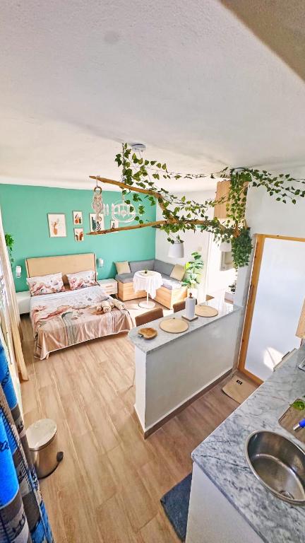 a living room with a bed and a sink at Rooftop Treehouse - Hammam Sousse in Sousse