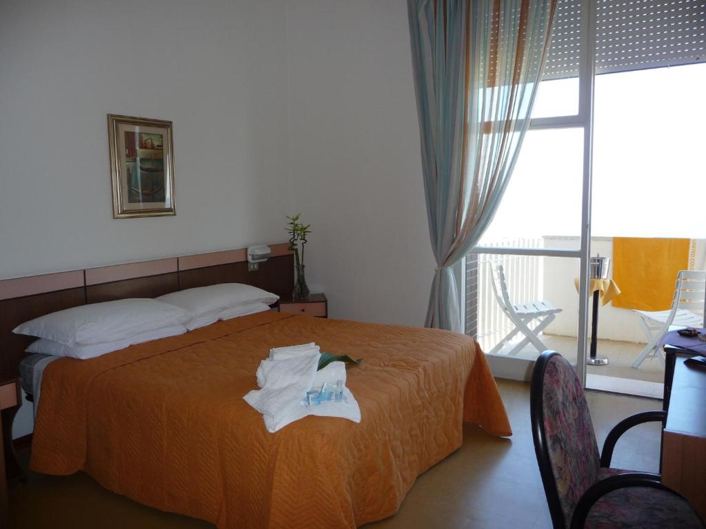 Postel nebo postele na pokoji v ubytování Hotel Suprem sul Mare