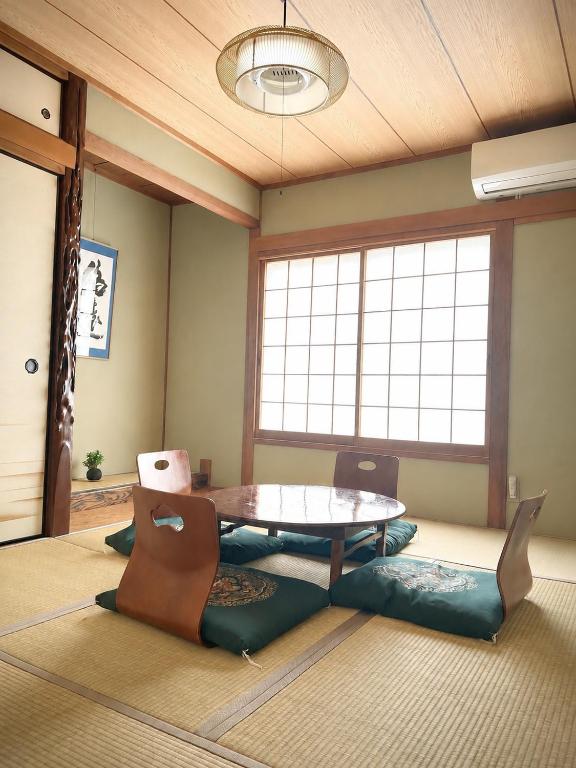 a living room with a table and chairs at Hirakata house, Easy Access to Kyoto and Osaka in Hirakata