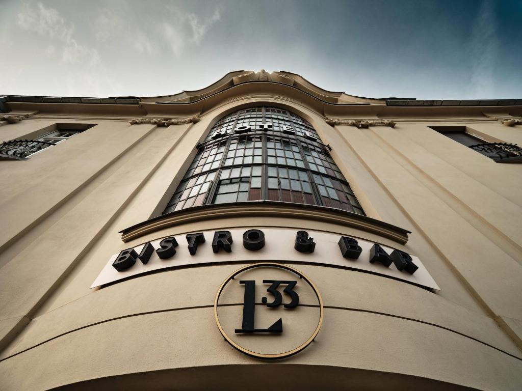a building with a clock on the front of it at Liberté 33, an Ascend Collection Hotel in Poznań
