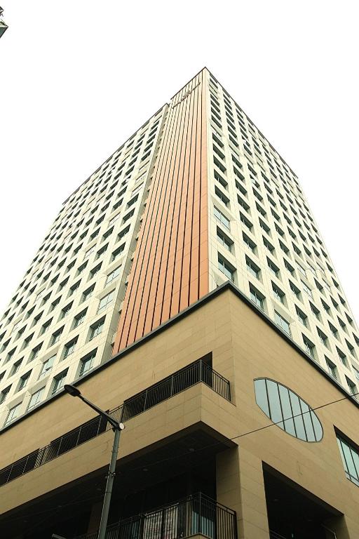 a tall office building with at The Bayment Stay in Busan