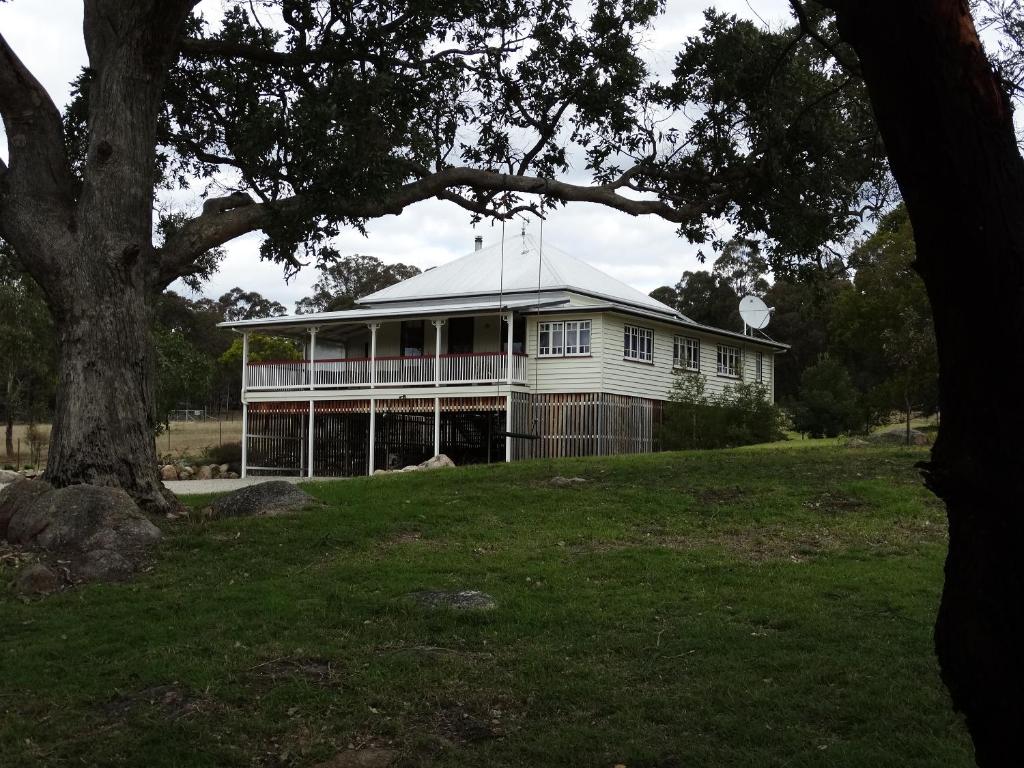 a white house with a tree in front of it at Loughmore House in Eukey