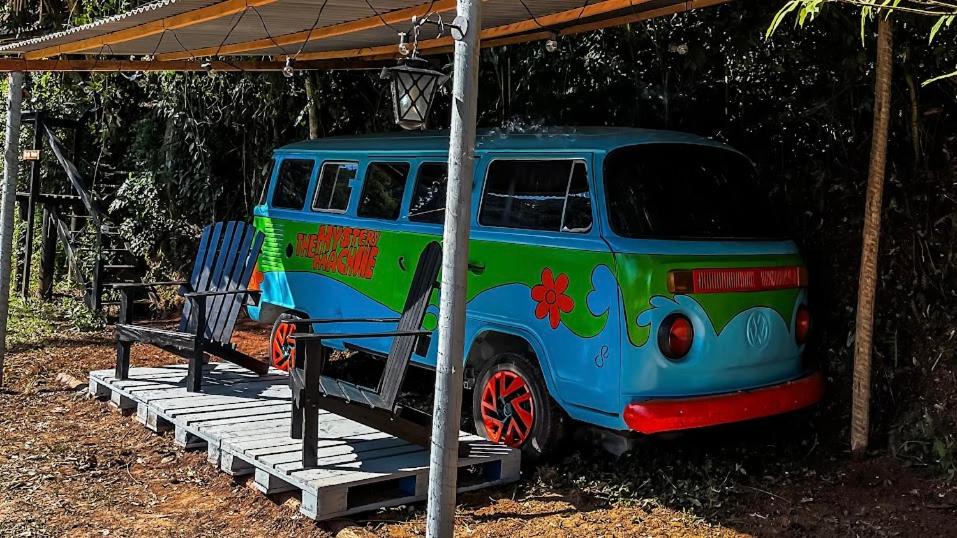 a colorful van parked under a roof at Kombi do Scooby-Doo in Mairiporã