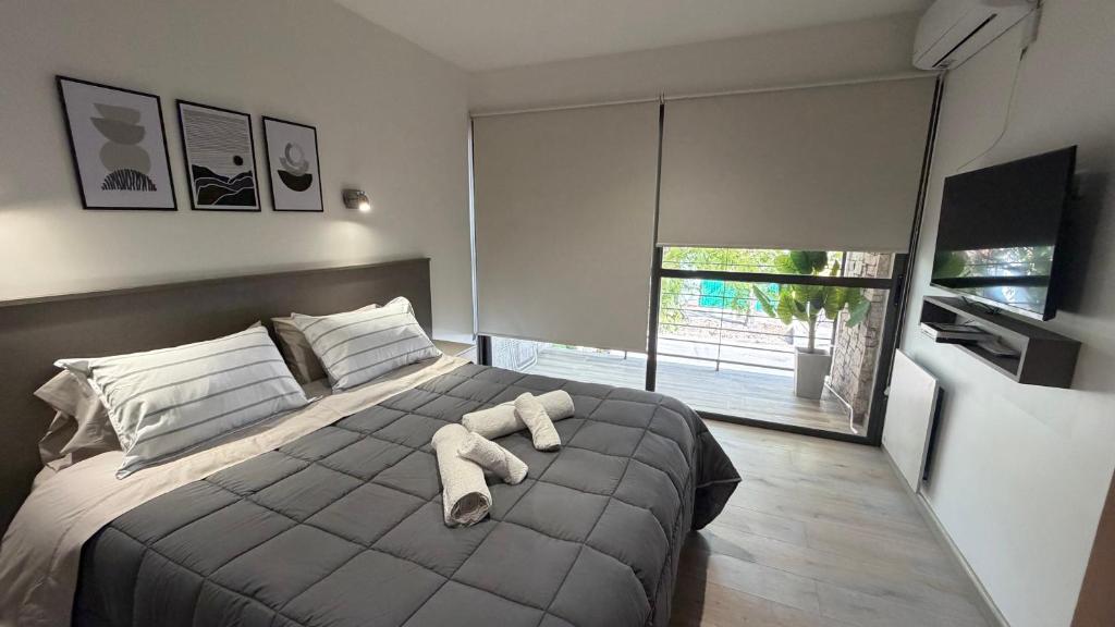 a bedroom with a bed with a stuffed animal on it at Base de los Andes 4 in Maipú