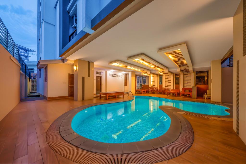 a pool in the middle of a building at Tycoon Holiday Hotel in Pattaya