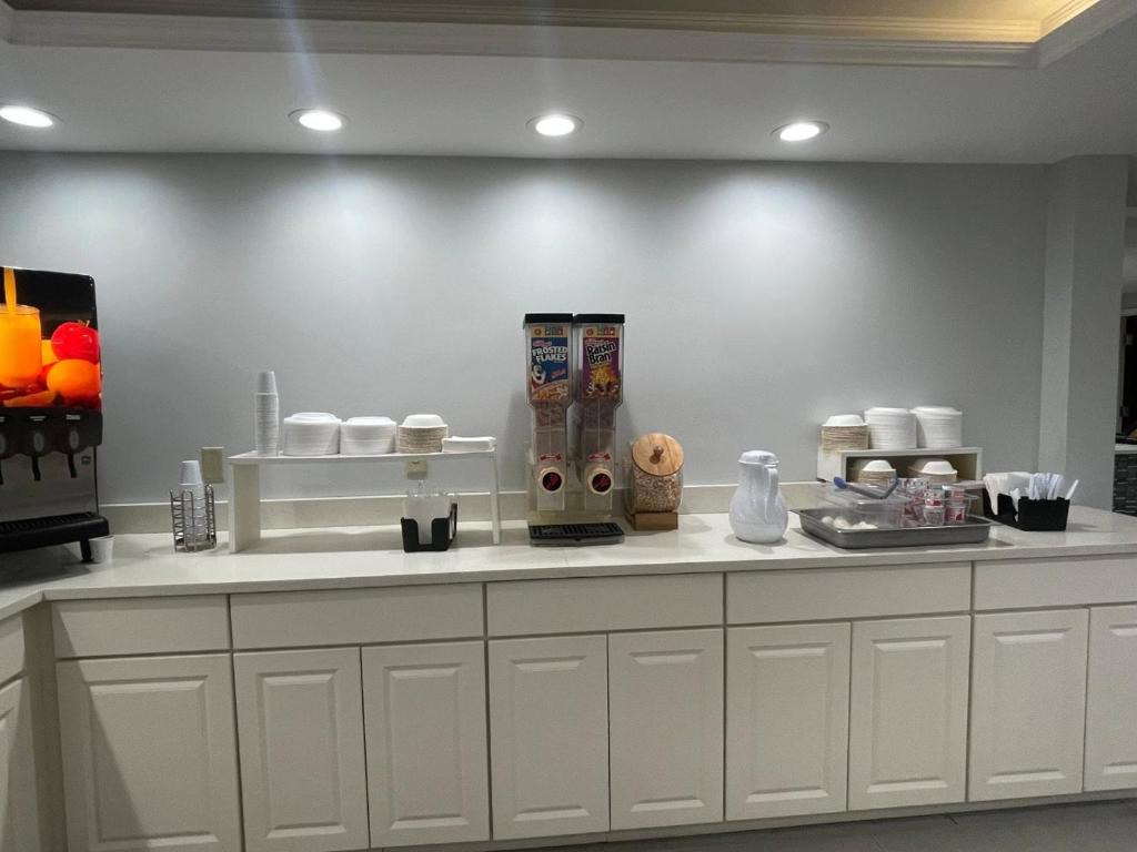 a kitchen with white cabinets and a counter top at Inn at Portland in Portland