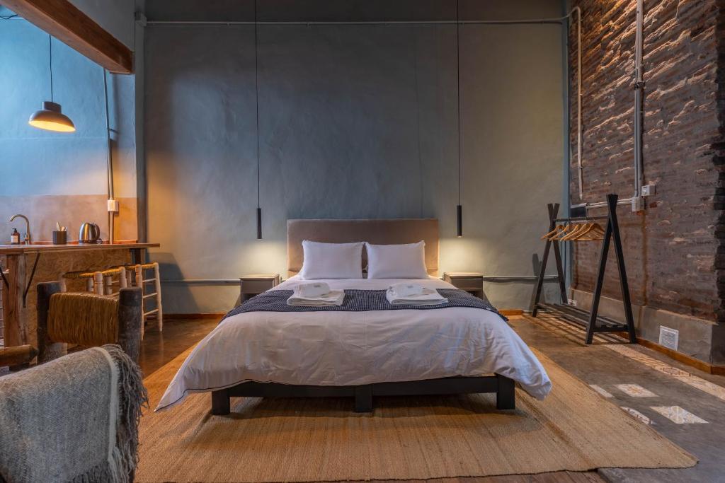 a bedroom with a large bed in a room at La Piamonte 1903 in Azcuénaga
