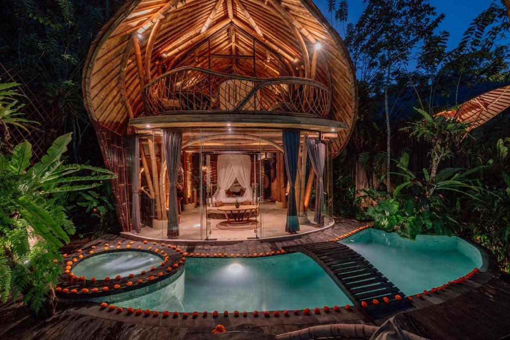 a villa with a swimming pool and a house at Jiva Bali - Green Dream Suites in Selat