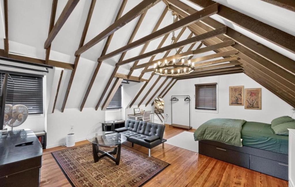 a bedroom with a bed and a couch and a table at Studio Apartment in Smithtown