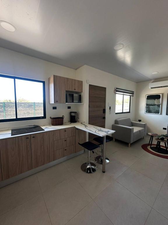 a kitchen and living room with a table and a couch at Temptika Villa 2, New Property in Tempate
