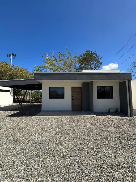 a small white house with a garage at Temptika Villa 1, New Property in Tempate