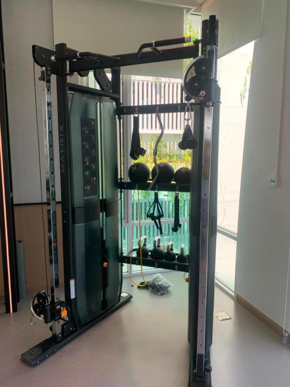 a room with a gym with a large window at The Title Serenity Naiyang in Ban Bo Han
