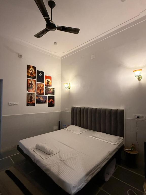 a bed in a room with a ceiling fan at Ajay Niwas in Udaipur
