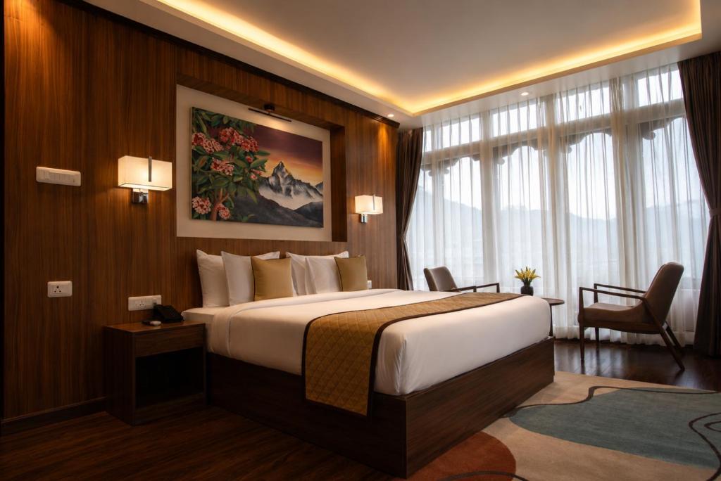 a bedroom with a large bed in a hotel room at Tshang RI in Thimphu