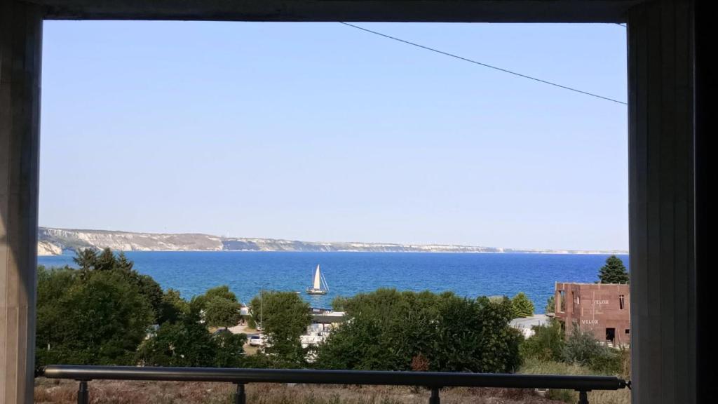 a view of the ocean from a window at Sea View in Topola