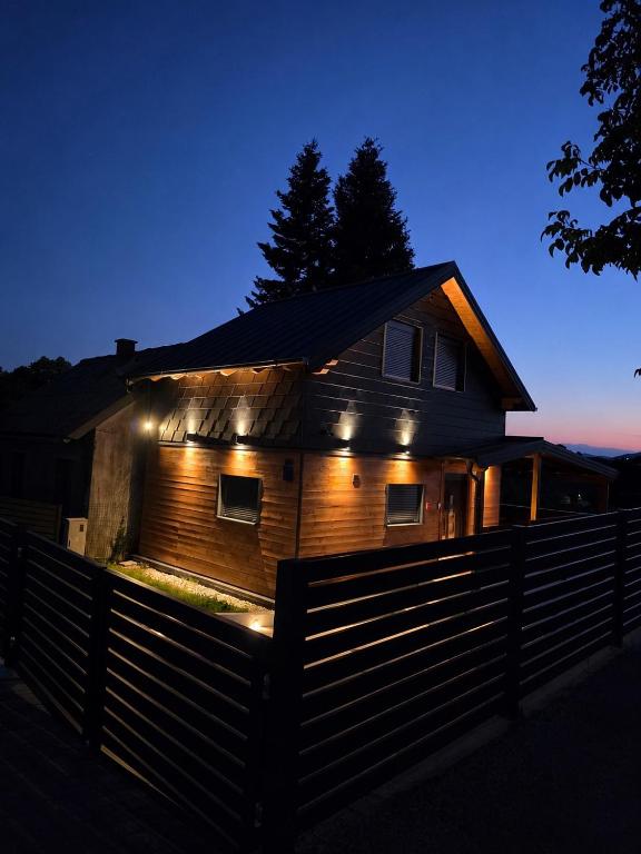 a house with lights on the side of it at night at Luni Stay - Jacuzzi, Sauna & Nature Escape in Jastrebarsko