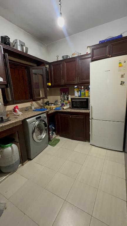 a kitchen with a refrigerator and a washing machine at Martil in Martil