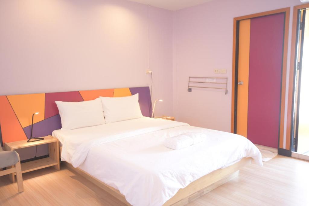 a bedroom with a large white bed in it at Room@Vipa in Bangkok