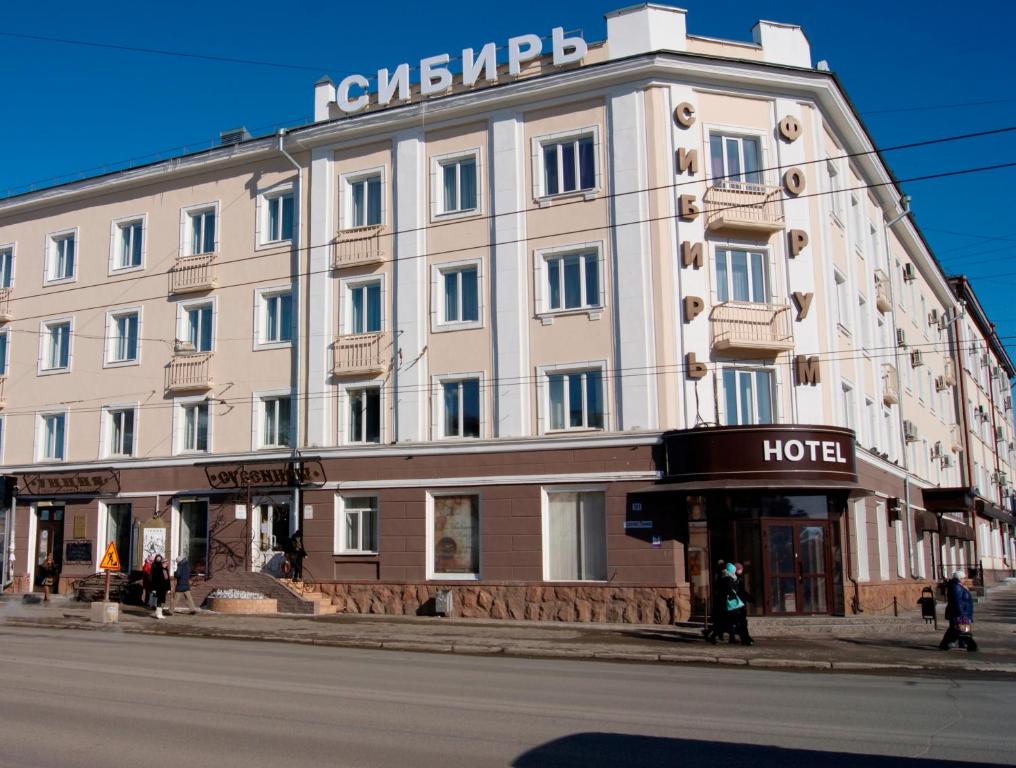 トムスクにあるSibir Hotelの通角の白い大きな建物