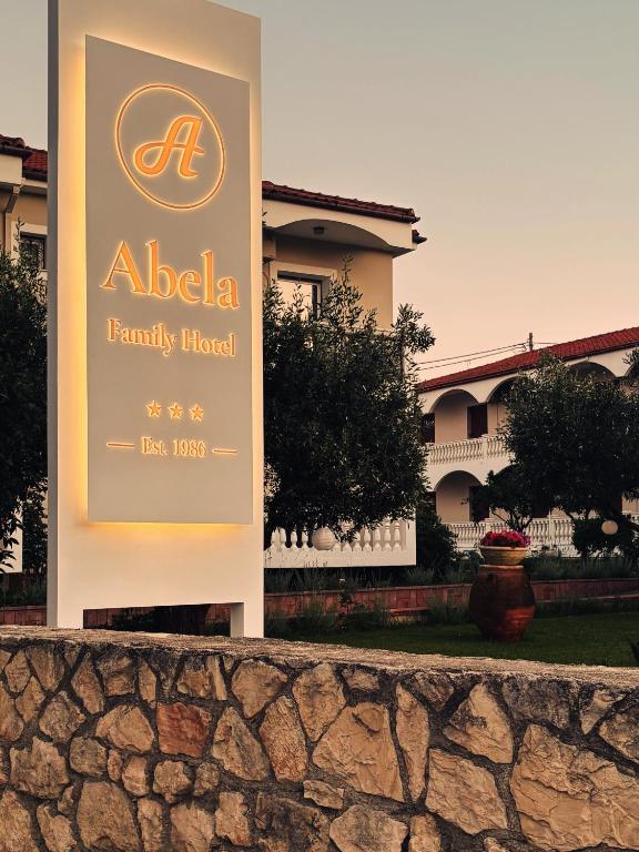a sign for aania family hospital in front of a house at Abela Family Hotel in Argassi