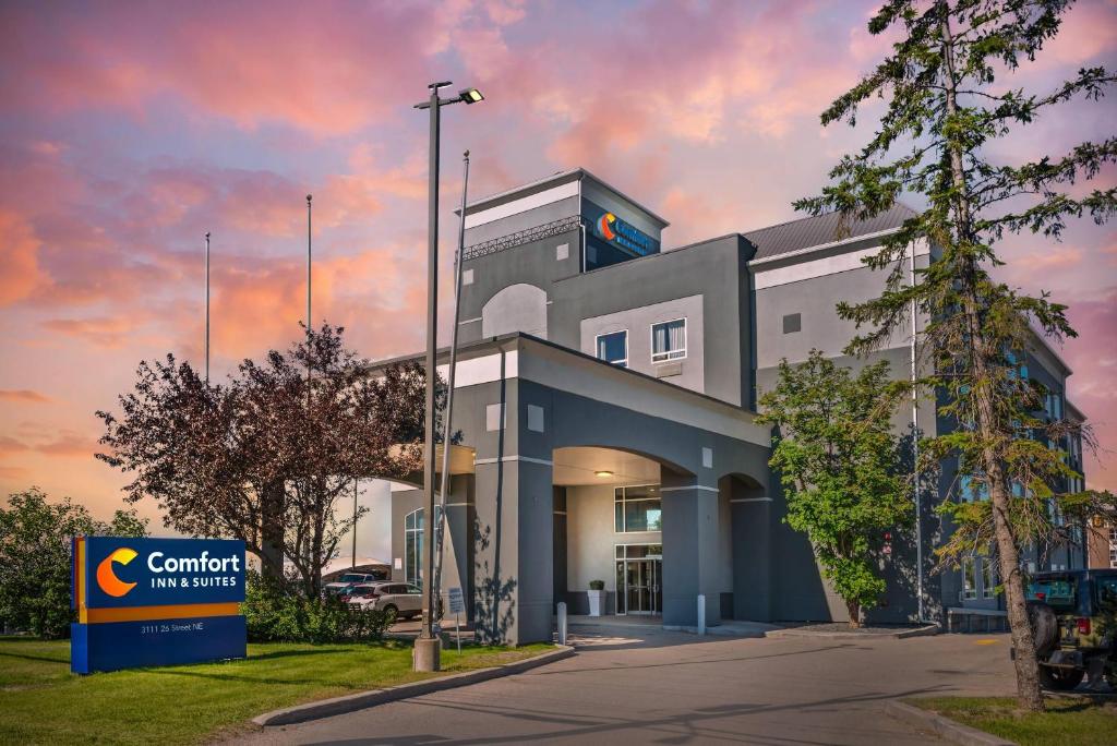 a building with a sign in front of it at Comfort Inn & Suites Airport South in Calgary