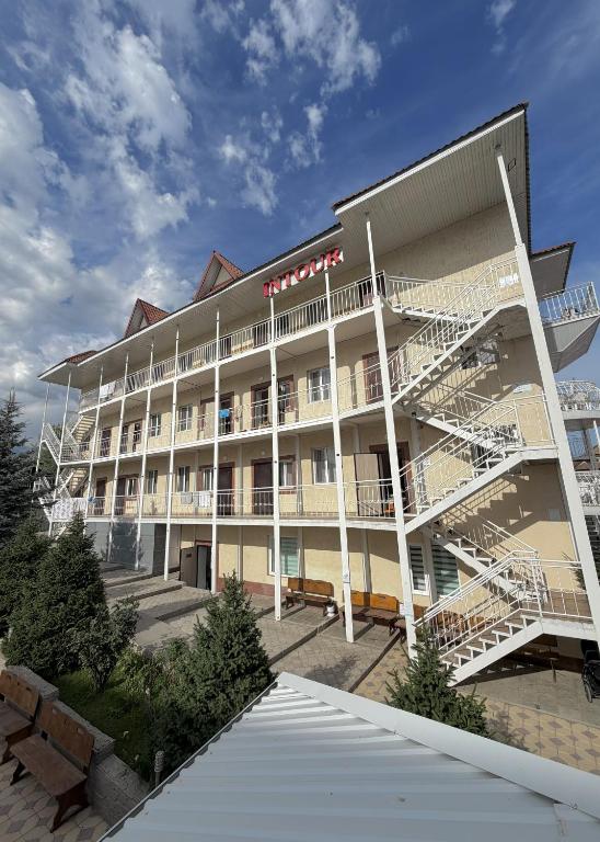 a large building with stairs in front of it at Intour in Cholpon-Ata