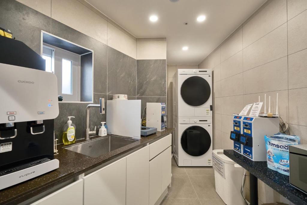 a kitchen with a sink and a dishwasher at Mega Stay Dongdaemun in Seoul