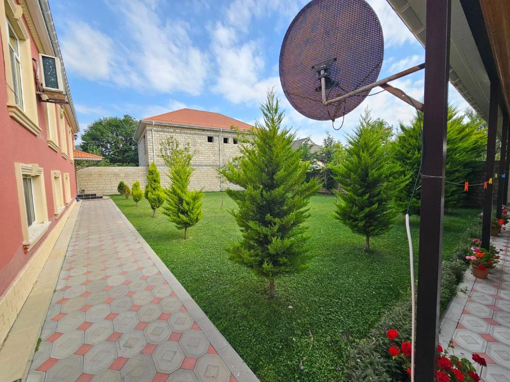 a view of a yard with trees and a basketball hoop at Green Garden RHB in Gabala