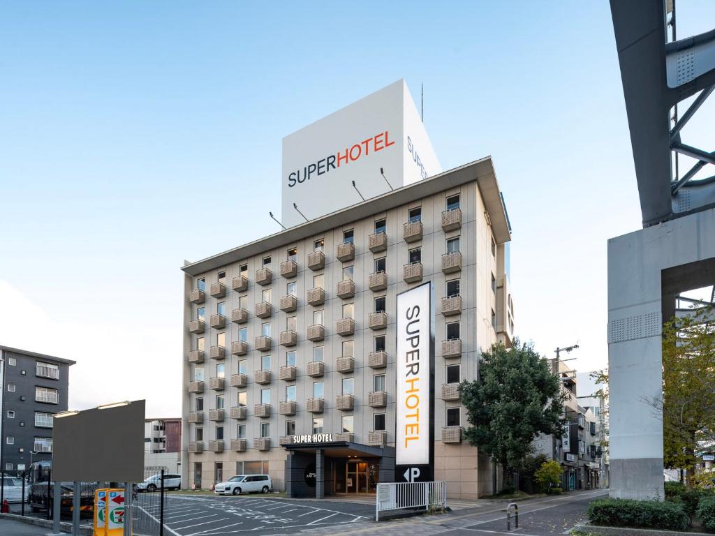 a hotel building with a sign in front of it at Super Hotel Kadoma in Kadoma