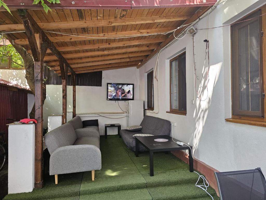 a living room with a couch and a table at HOSTEL SPORT BUCHAREST in Bucharest