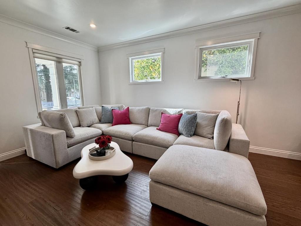 a living room with a couch and a table at Designer Garden Retreat in San Jose