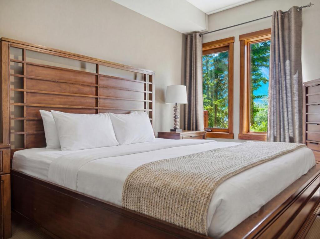 a bedroom with a large bed and a window at Spacious Getaway near Banff with Heated Pool in Canmore