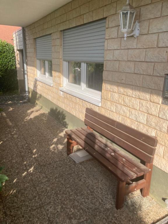 a wooden bench sitting in front of a building at Evelyn in Emmelshausen