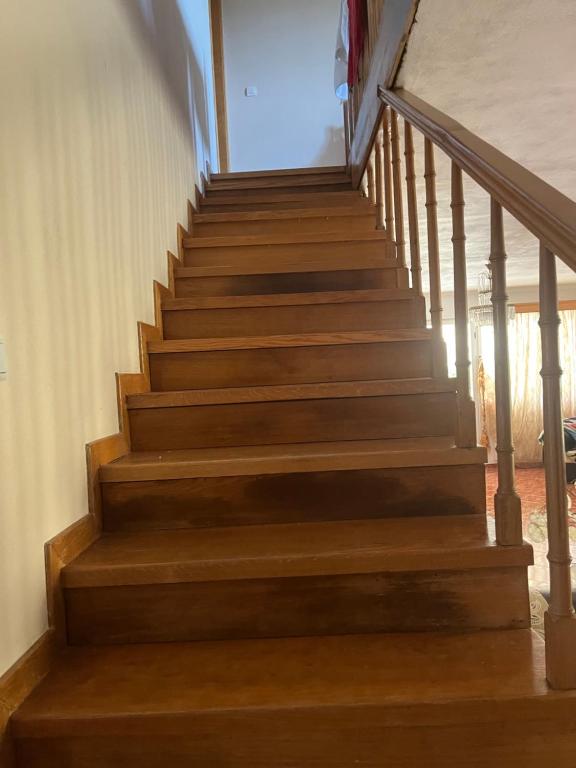 a staircase in a house with wooden steps at Templa in Himare