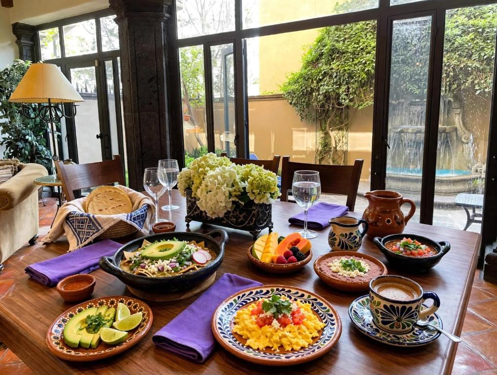 a wooden table with plates of food on it at Casa Grande Luxury Boutique Hotel in San Miguel de Allende