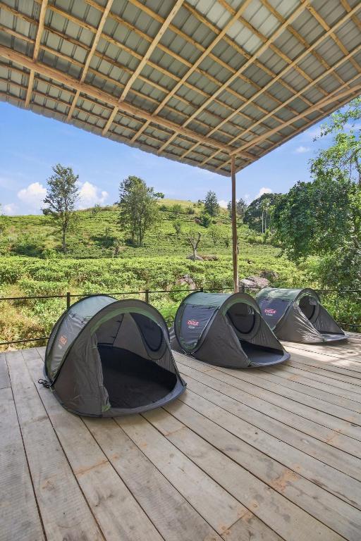 three tents sitting on a deck under a roof at Jungle Nest Ella in Ella