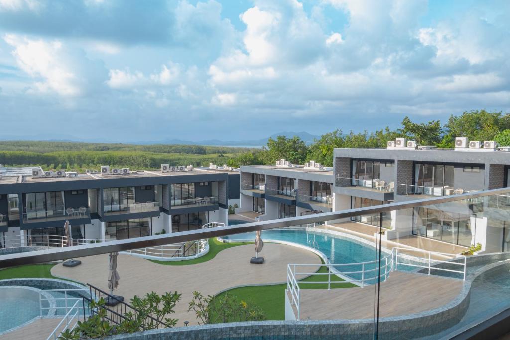 arial view of an apartment complex with a swimming pool at Elite Suites Villas Maikhao Phuket in Mai Khao Beach