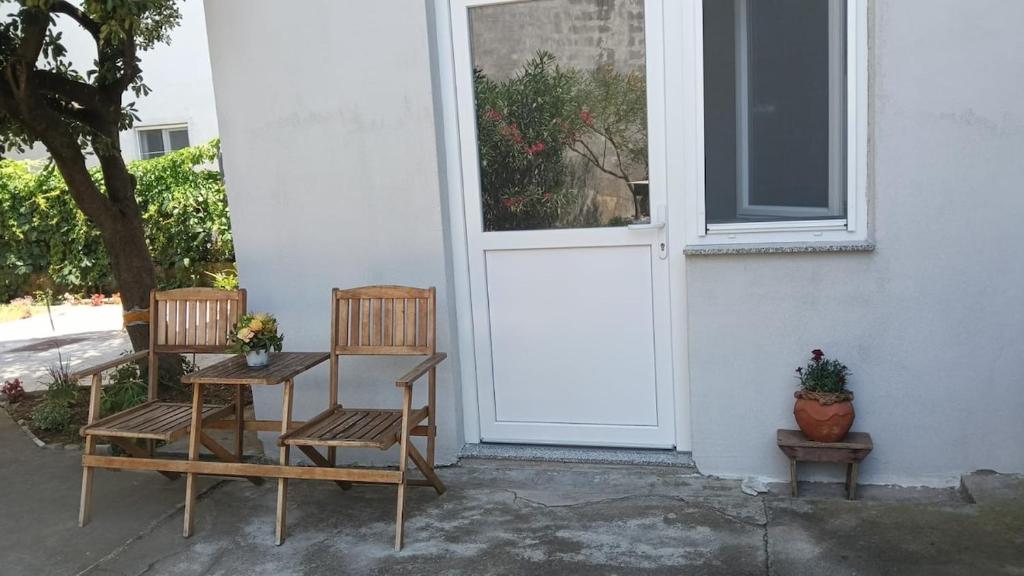 two chairs and a table in front of a door at Zadar Sunhouse Studio with Terrace in Zadar