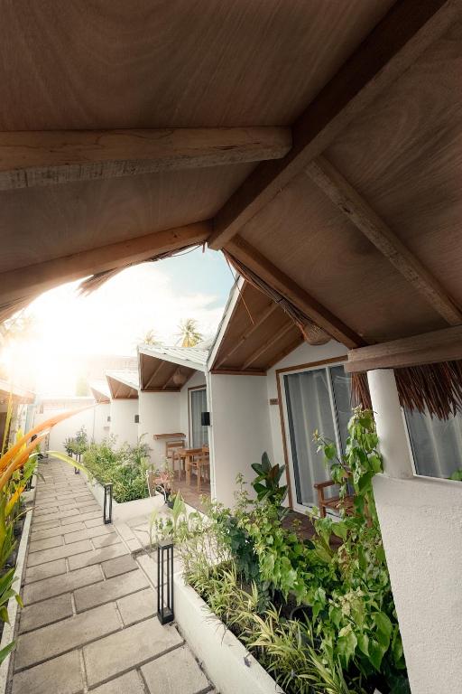 an outside view of a building with a patio with plants at Boli Dhigurah in Dhigurah