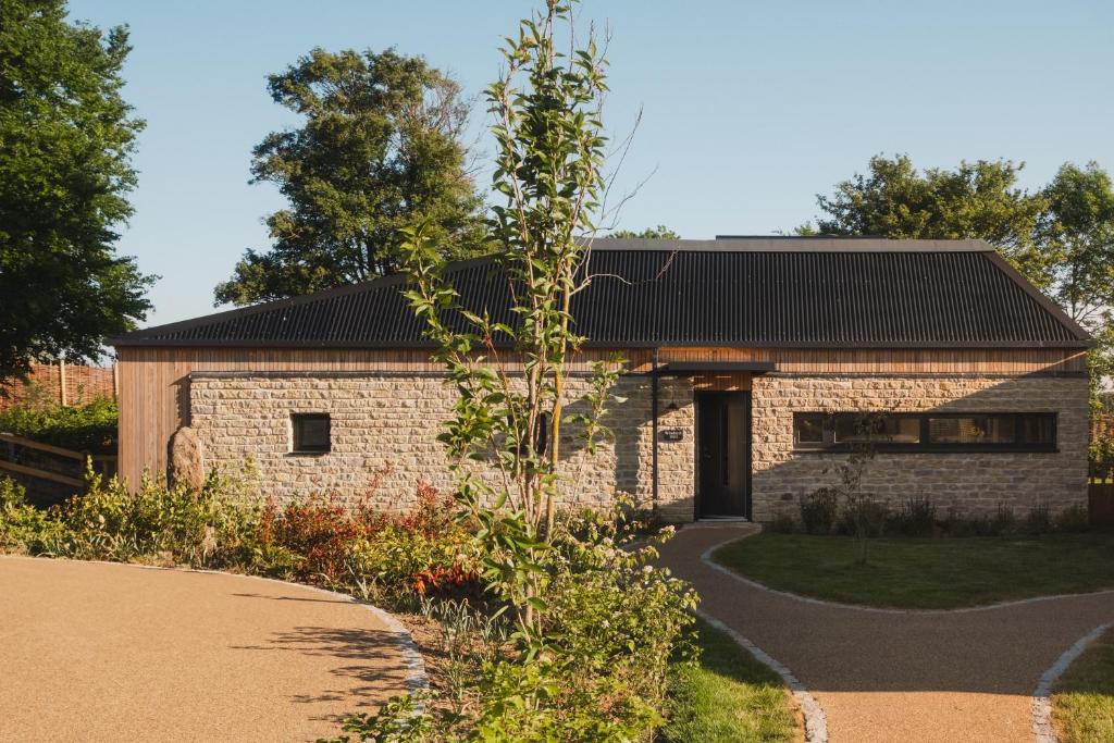 a brick house with a black roof at Windmill Hill in Marlborough
