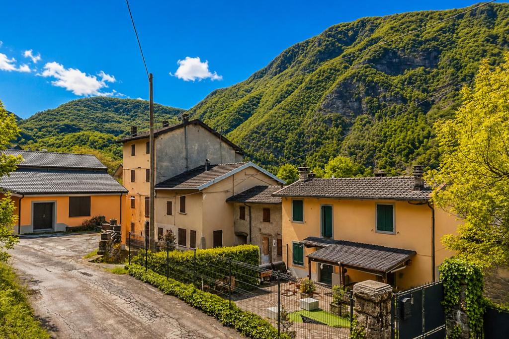 a village in front of a mountain at Casa al Sasso - Appartamenti immersi nella natura in Lizzano in Belvedere