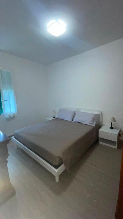 a bedroom with a bed in a white room at Ca' di Miglietto in Varigotti