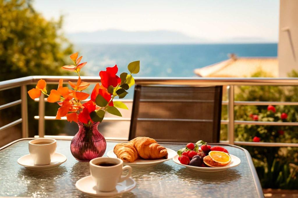 a table with two cups of coffee and a plate of food at Seaside Getaway - Aelia Villa's Dreamy Paradise in Petalidi