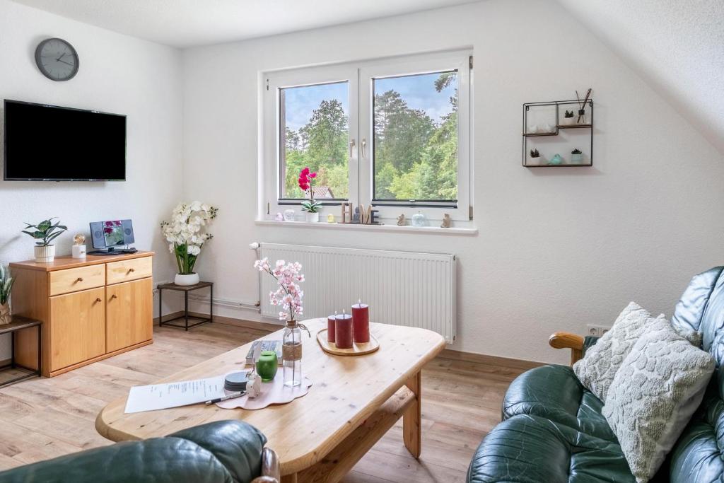 a living room with a table and a couch at Tanne in Sprakensehl