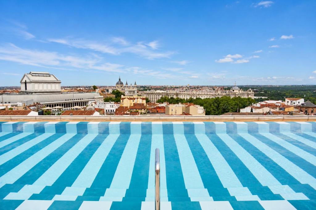 a swimming pool with a view of the city at Urban Hive Madrid in Madrid