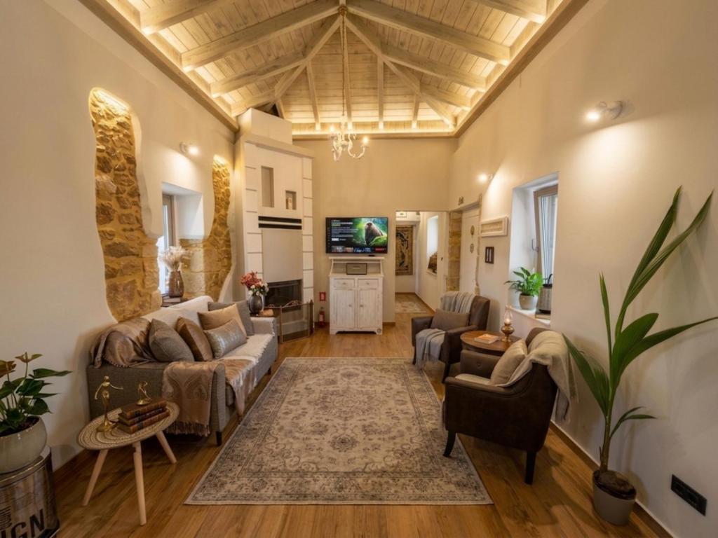 a living room with a couch and a tv at Villa Katrinia in Sitia