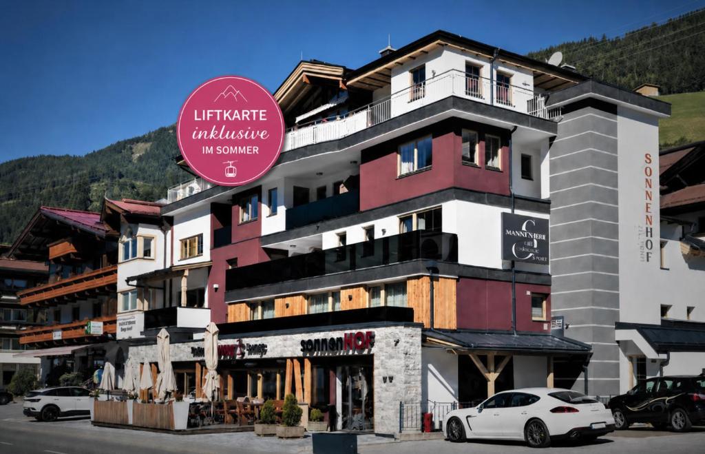a building with a sign in front of it at SonnenHOF hotel gerlos centrum in Gerlos