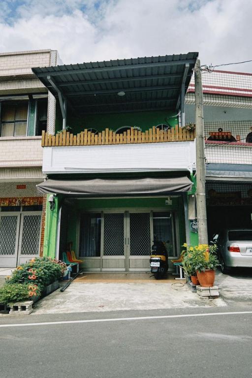 a building with a garage with a car parked in it at Ajuan Homestay in Hengchun South Gate