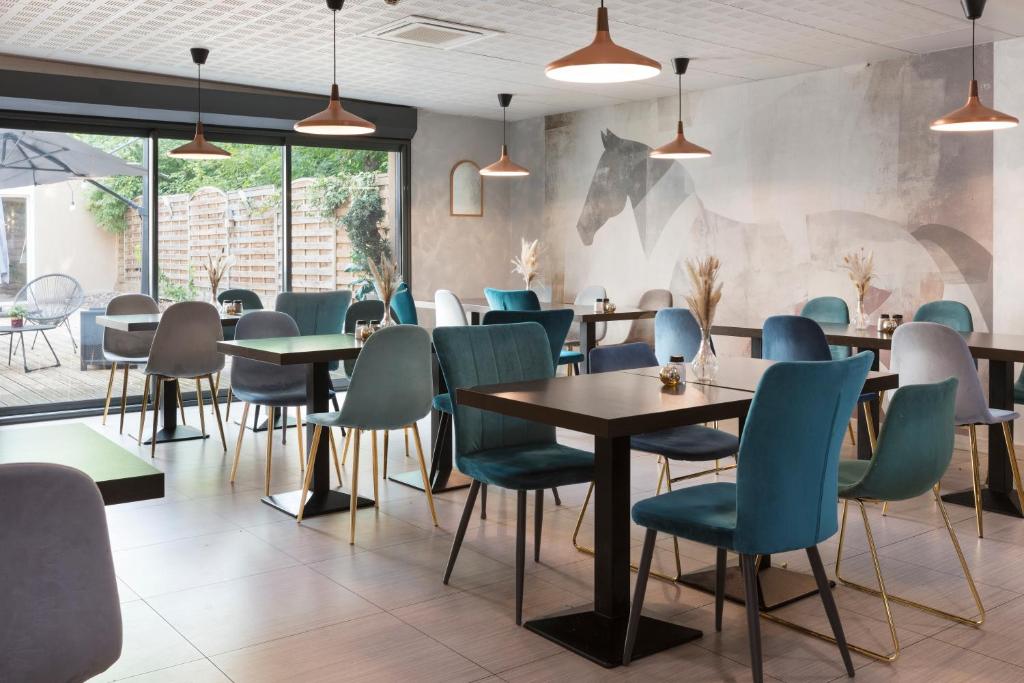 a dining room with tables and chairs at Sure Hotel by Best Western Reims Nord in Reims
