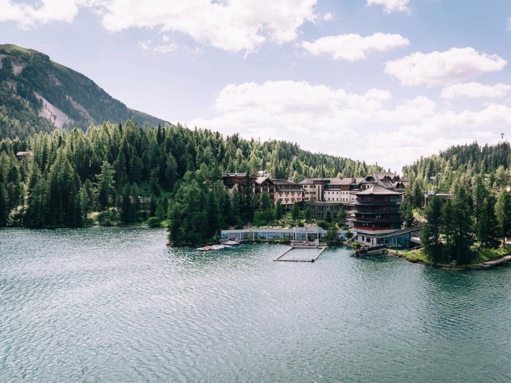 a resort on a lake in the middle of a mountain at Hotel Hochschober in Turracher Hohe